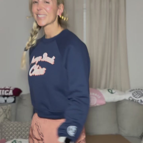 Navy blue with White puff print and outlined in orange and its a cropped. 