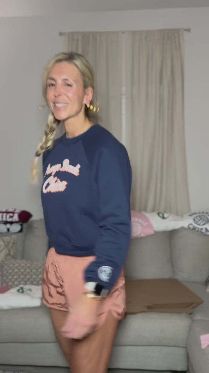 Navy blue with White puff print and outlined in orange and its a cropped. 